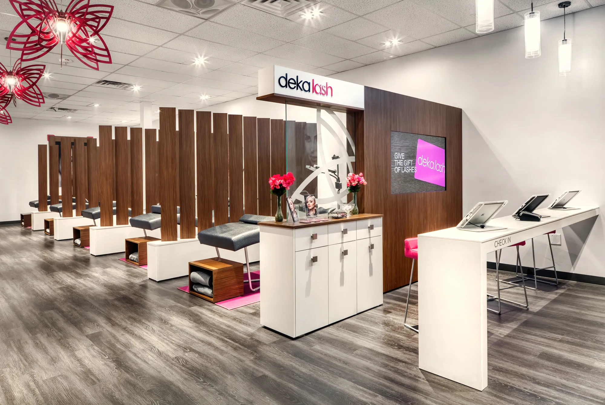 Check-in desk and lash beds inside a Deka Lash studio.